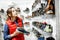 Woman choosing shoes for hiking in the shop