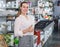 Woman choosing stainless cutlery sets in dinnerware shop