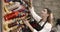 Woman choosing threads for dressmaking in a shop