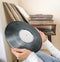 Woman choosing vinyl records at home for listening