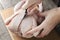 woman chopping a chicken with a knife on a cutting board