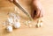 Woman chopping garlic on wooden board