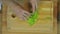 Woman Chopping Lettuce at Wooden Kitchen Table