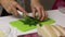 A woman is chopping parsley. Lard lies nearby. Salted lard with herbs and spices