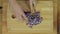 Woman Chopping Purple Onion at Wooden Kitchen Table