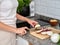 woman chopping the vegetables into slices to prepare a tabbouleh