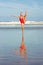 Woman in Christmas hat doing standing splits