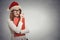Woman with christmas hat is posing in studio thinking of gift ideas