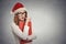 Woman with christmas hat is posing in studio thinking of gift ideas