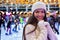 Woman on a Christmas ice rink enjoys the winter feeling