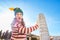 Woman in Christmas tree hat supporting Leaning Tour of Pisa