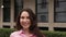 woman circles around herself against the background of business center building