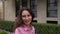 woman circles around herself against a modern business center building