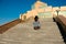 Woman on a city street climbs the stairs