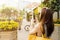 Woman on city tour taking picture of beautiful cafe flowers with her smartphone