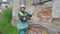 Woman civil engineer examining old brick wall condition