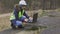 Woman civil engineer using laptop on cracked concrete slabs