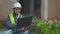 Woman civil engineer writing data on laptop