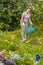 woman clean up garbage dump in nature.