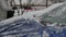 Woman Cleaning blue Car After Snowfall.