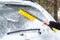 Woman cleaning car from snow with brush. Transportation, winter,