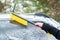 Woman cleaning car from snow with brush. Transportation, winter,