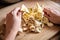 Woman cleaning cultivated golden oyster mushrooms in the kitchen