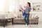 Woman with cleaning equipment ready to clean room