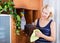 Woman cleaning furniture at home