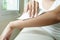 Woman cleaning her arm with white soft tissue paper