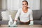 Woman cleaning home, table and living room with a chemical disinfectant soap spray bottle to clean house dirt. Adult