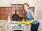 Woman cleaning house. Beautiful girl polishing oven in the kitchen.