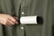 Woman cleaning khaki shirt with lint roller
