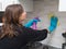 Woman cleaning kitchen tiles