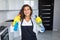 Woman cleaning kitchen. Young woman washing kitchen hood