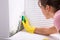 Woman Cleaning Mold From Wall