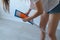 Woman is cleaning and mopping the linoleum floor, legs close-up.