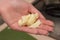 Woman cleaning potatoes with her hands