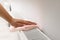 Woman cleaning radiator with rag indoors, closeup