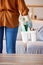 Woman, cleaning services and basket with product tools in living room, lounge and home. Closeup cleaner, maid and