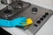 Woman cleaning stainless steel gas surface in the kitchen at ho