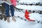 Woman cleaning stairs from snow with shovel on winter day, closeup