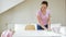 Woman cleaning table with microfiber cloth at home