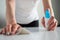 Woman cleaning white table with wet wipe - disinfection concept