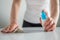 Woman cleaning white table with wet wipe - disinfection concept