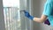 Woman cleaning window. Stock video of an anonymous housewife or cleaner washing the window with a squeegee.