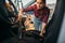 Woman cleans car interior with vacuum cleaner