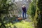 Woman cleans the garden in early spring