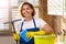Woman cleans the house. The woman is holding a mop and a bucket and gloves and a cleaning sponge