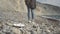 A woman cleans the sea shore from garbage. Volunteer ecologist person removes rubbish on the beach